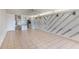 Spacious living room featuring neutral tile floors, unique wall design and natural light at 2980 Haines Bayshore Rd # 105, Clearwater, FL 33760