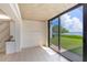 Bright living room features tile flooring and sliding doors with a water view at 2980 Haines Bayshore Rd # 105, Clearwater, FL 33760
