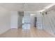 Open living area featuring neutral tile floors, ceiling fan, and a view of kitchen area at 2980 Haines Bayshore Rd # 105, Clearwater, FL 33760