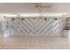 Bright living room featuring a chevron wall, neutral tile floors and ceiling fan at 2980 Haines Bayshore Rd # 105, Clearwater, FL 33760