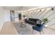 Living room area featuring a gray rug, sofa, and unique chevron wall design at 2980 Haines Bayshore Rd # 105, Clearwater, FL 33760