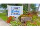 Caribay community sign surrounded by colorful flowers and lush greenery at 2980 Haines Bayshore Rd # 105, Clearwater, FL 33760