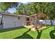 Backyard with a pergola-covered patio and artificial grass at 3127 W Oakellar Ave, Tampa, FL 33611