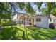 Backyard featuring a pergola-covered patio, grill, and shed at 3127 W Oakellar Ave, Tampa, FL 33611