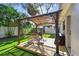 Backyard featuring a pergola-covered patio, grill, and shed at 3127 W Oakellar Ave, Tampa, FL 33611