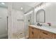 Stylish bathroom featuring a glass enclosed shower and wooden vanity with a marble countertop at 3127 W Oakellar Ave, Tampa, FL 33611