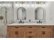 Bright bathroom features a wooden double vanity with a marble countertop and modern fixtures at 3127 W Oakellar Ave, Tampa, FL 33611