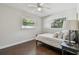 This bright bedroom features hardwood floors and two windows with views at 3127 W Oakellar Ave, Tampa, FL 33611