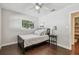 Comfortable bedroom with fan, hardwood floors, and a natural light at 3127 W Oakellar Ave, Tampa, FL 33611