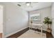 Cozy bedroom featuring a ceiling fan, wooden floors, and natural light at 3127 W Oakellar Ave, Tampa, FL 33611