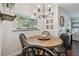 Sunlit dining area with a round wooden table and charming chandelier at 3127 W Oakellar Ave, Tampa, FL 33611