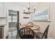 Inviting dining area features a round table, modern chandelier, and a view of the living space at 3127 W Oakellar Ave, Tampa, FL 33611