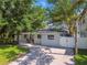 Charming single-story home with a freshly painted exterior, brick driveway, and gated entry at 3127 W Oakellar Ave, Tampa, FL 33611