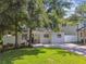 Charming single-story home with a freshly painted exterior, brick driveway, and gated entry at 3127 W Oakellar Ave, Tampa, FL 33611