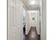 Hallway with wood floors and multiple doors leading to different rooms at 3127 W Oakellar Ave, Tampa, FL 33611