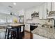 Bright kitchen with stainless steel appliances, granite counters, and a stylish island at 3127 W Oakellar Ave, Tampa, FL 33611