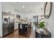 Updated kitchen with white cabinetry, hardwood floors, stainless steel appliances, and an island with bar seating at 3127 W Oakellar Ave, Tampa, FL 33611