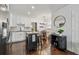 Modern kitchen featuring white cabinets, stainless steel appliances, hardwood floors, and island with bar seating at 3127 W Oakellar Ave, Tampa, FL 33611