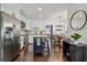 Contemporary kitchen featuring stainless steel appliances, white cabinets, hardwood floors, and island with bar stool seating at 3127 W Oakellar Ave, Tampa, FL 33611
