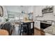 Open-concept kitchen and living area with modern appliances and a convenient island at 3127 W Oakellar Ave, Tampa, FL 33611