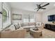 Comfortable living room with hardwood floors, neutral sofa, bright natural light, and stylish decor at 3127 W Oakellar Ave, Tampa, FL 33611