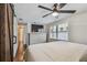 Bright main bedroom with a mounted TV, ample storage, and a rustic barn door at 3127 W Oakellar Ave, Tampa, FL 33611