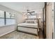 Serene main bedroom with a large bed, soft lighting, and a decorative sliding barn door at 3127 W Oakellar Ave, Tampa, FL 33611