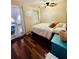 Cozy bedroom featuring hardwood floors, neutral walls, and natural light from door and window at 3135 33Rd N Ave, St Petersburg, FL 33713