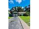 Charming single-story home featuring an attached garage and a well-maintained lawn, with mature trees in the background at 3135 33Rd N Ave, St Petersburg, FL 33713