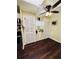 Hallway displaying the neutral walls, dark floors, storage, and access to other parts of the house at 3135 33Rd N Ave, St Petersburg, FL 33713