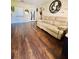 Spacious living room with warm wood floors, a plush sofa, and stylish decor, perfect for relaxation at 3135 33Rd N Ave, St Petersburg, FL 33713
