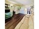Bright and airy living room with wood floors, a comfortable sofa, and seamless transition to the kitchen at 3135 33Rd N Ave, St Petersburg, FL 33713