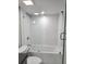 Bright bathroom features a glass-enclosed shower/tub with tile surround at 3325 Bayshore Blvd # C14, Tampa, FL 33629