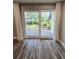 Sliding glass doors leading to the outdoors, curtains, and wooden floor at 3325 Bayshore Blvd # C14, Tampa, FL 33629