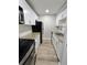 Galley kitchen boasts granite countertops, stainless appliances, white cabinets, and wood look tile at 3325 Bayshore Blvd # C14, Tampa, FL 33629