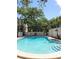 Community pool with lounge chairs and stairs into the pool at 3325 Bayshore Blvd # C14, Tampa, FL 33629
