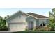 Charming single-story home with a two-car garage, stone accents, and manicured landscaping at 3340 Ivy Hollow Dr, Plant City, FL 33565