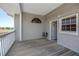Covered balcony showcasing wood flooring, gray siding, and scenic waterfront views at 340 Bay Plaza, Treasure Island, FL 33706