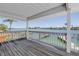 Covered balcony with wood flooring offers stunning waterfront views at 340 Bay Plaza, Treasure Island, FL 33706
