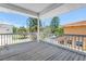 Balcony with a light-colored ceiling and wood flooring, surrounded by lush trees at 340 Bay Plaza, Treasure Island, FL 33706