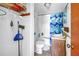 Bathroom featuring themed shower curtain, toilet, and vanity with storage at 340 Bay Plaza, Treasure Island, FL 33706