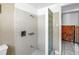 Bathroom with a shower, tiled walls, and glass block partition at 340 Bay Plaza, Treasure Island, FL 33706