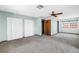 Spacious bedroom featuring a large window, ceiling fan and large closets at 340 Bay Plaza, Treasure Island, FL 33706