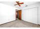 Bright bedroom featuring a ceiling fan, closet, and neutral carpeting at 340 Bay Plaza, Treasure Island, FL 33706