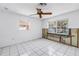 Bedroom with a ceiling fan, tile flooring, and windows overlooking the waterfront at 340 Bay Plaza, Treasure Island, FL 33706