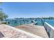 Wide angle showing private wood dock, boat lift, clear water and city views at 340 Bay Plaza, Treasure Island, FL 33706