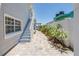 Charming exterior view of home with brick walkway, garden, and view of the serene water at 340 Bay Plaza, Treasure Island, FL 33706