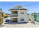 Two-story home featuring a front porch, arched entry, and brick driveway at 340 Bay Plaza, Treasure Island, FL 33706