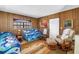 Cozy living room with paneled walls and comfortable seating with plenty of natural light at 340 Bay Plaza, Treasure Island, FL 33706