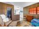 A cozy living room with paneled walls flowing into the breakfast bar and adjoining bathroom at 340 Bay Plaza, Treasure Island, FL 33706